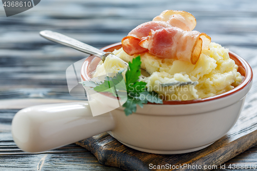 Image of Fork in bowl with mashed potatoes and bacon.