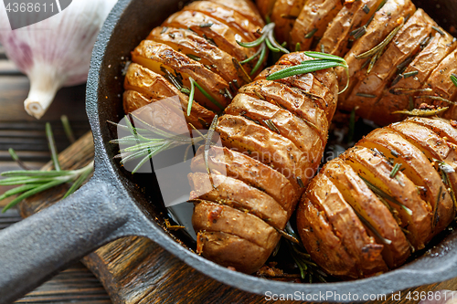 Image of Potatoes in their skins baked with rosemary.