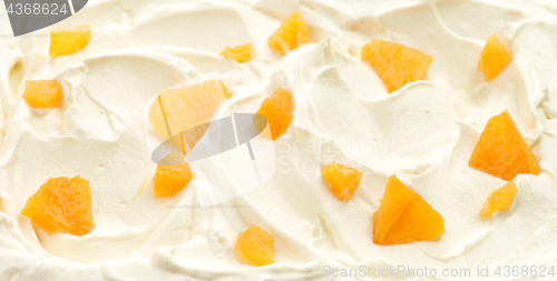 Image of whipped cream with orange pieces