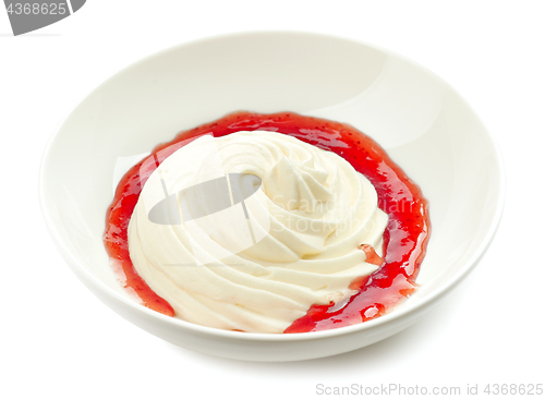 Image of whipped cream with strawberry sauce