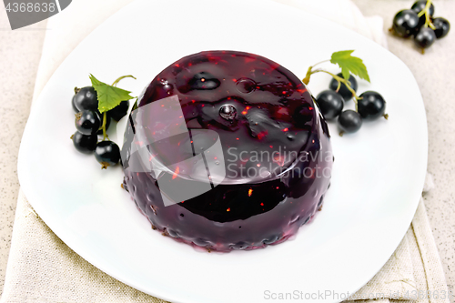 Image of Jelly from black currant with berries in plate on stone table