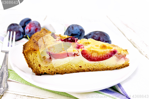 Image of Pie plum with sour cream in plate on napkin