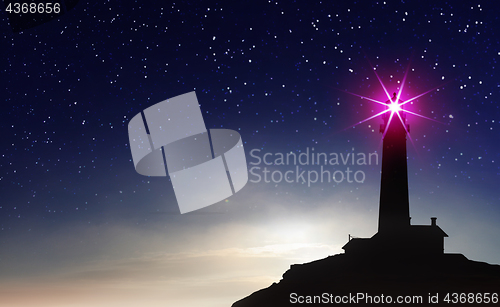 Image of silhouette of lighthouse at sunset