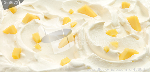 Image of whipped cream with mango pieces