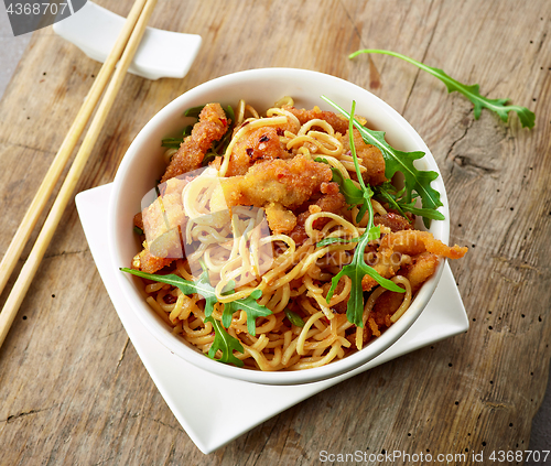 Image of Bowl of asian noodles with fried meat