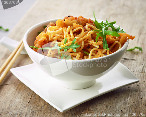 Image of Bowl of asian noodles with fried meat