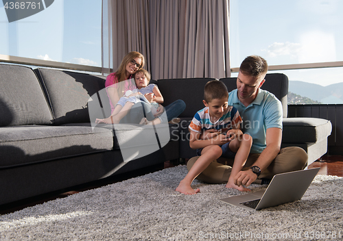 Image of Happy family playing a video game