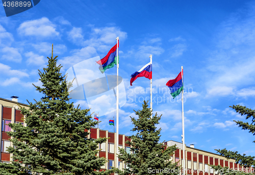 Image of State flag of Russia is flying in blue sky