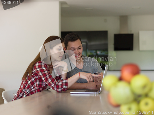 Image of happy young couple buying online