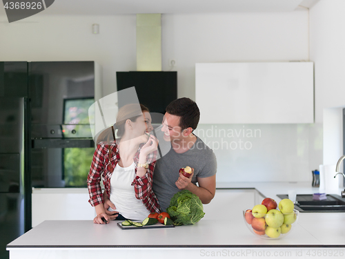 Image of Young handsome couple in the kitchen