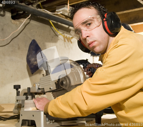 Image of Young Man Sawing Some Wood