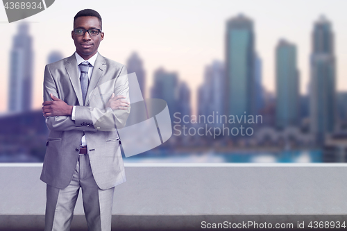 Image of Young black businessman in front of the big city