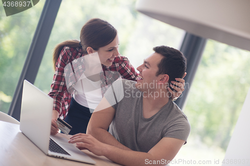 Image of happy young couple buying online