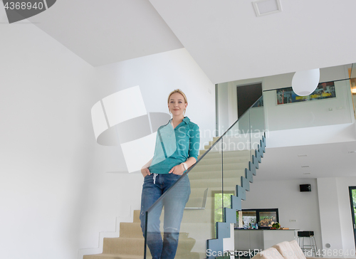 Image of portrait of a young beautiful woman on the stairs