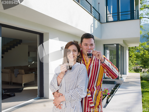 Image of Young beautiful couple in bathrobes