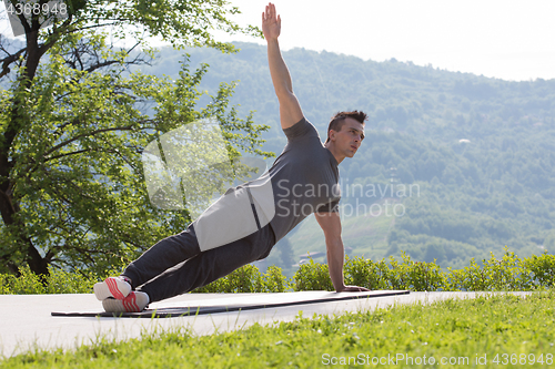 Image of man doing morning yoga exercises