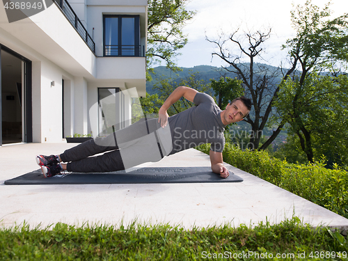 Image of man doing morning yoga exercises