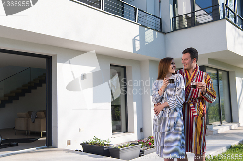 Image of Young beautiful couple in bathrobes