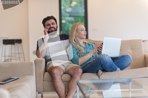 Image of young happy couple relaxes in the living room