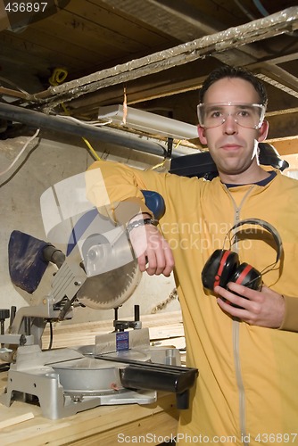 Image of Young Man Holding His Ear Protection