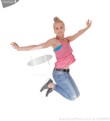 Image of Pretty woman jumping into the air