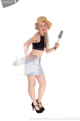 Image of Slim woman with straw hat and small shovel