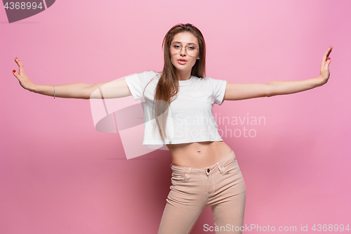 Image of Pretty young sexy fashion sensual woman posing on pink background dressed in hipster style jeans