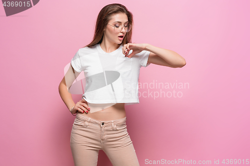 Image of Pretty young sexy fashion sensual woman posing on pink background dressed in hipster style jeans