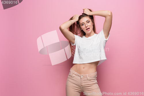 Image of Pretty young sexy fashion sensual woman posing on pink background dressed in hipster style jeans