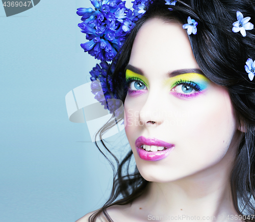 Image of Beauty young woman with flowers and make up close up, real sprin