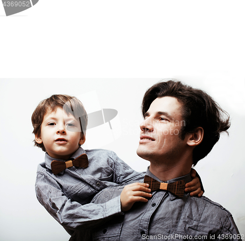 Image of father with son in bowties on white background, casual look