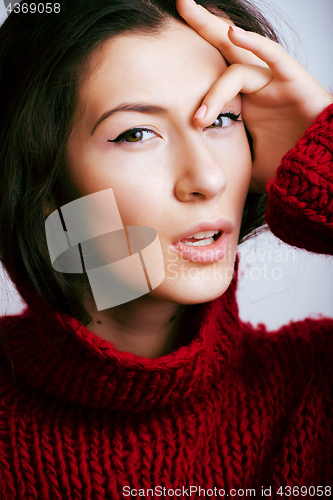 Image of young pretty woman in sweater and scarf all over her face, lifes