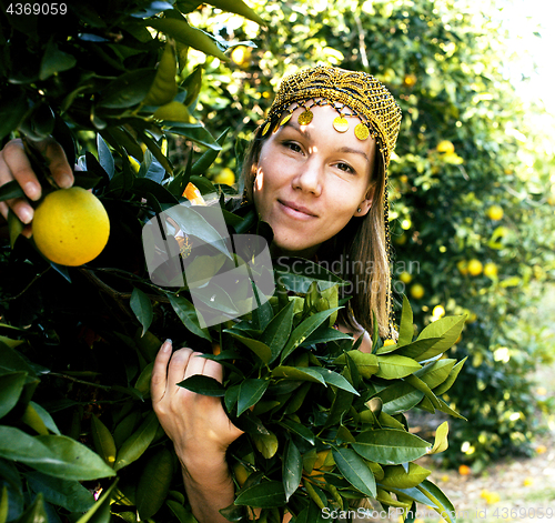 Image of pretty islam woman in orange grove smiling