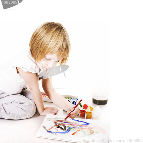 Image of little cute blond girl painting isolated