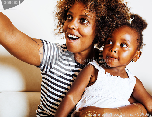 Image of adorable sweet young afro-american mother with cute little daugh