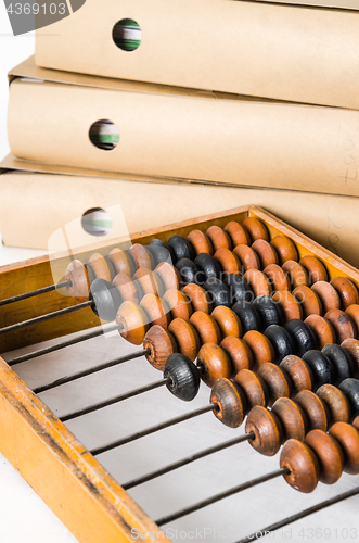 Image of Old abacus and folders with documents, close-up isolated on whit