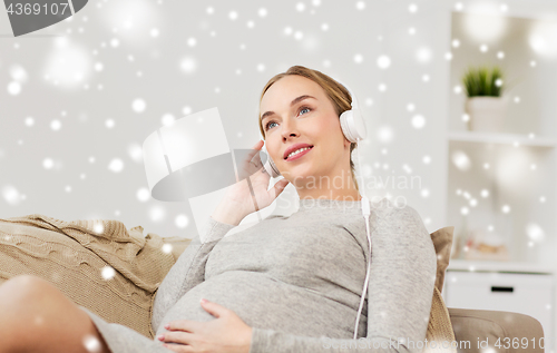 Image of pregnant woman with headphones listening to music