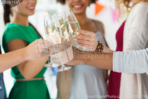 Image of friends clinking glasses of champagne at party