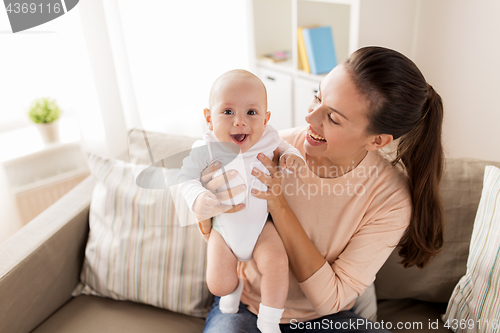 Image of happy mother with little baby boy at home