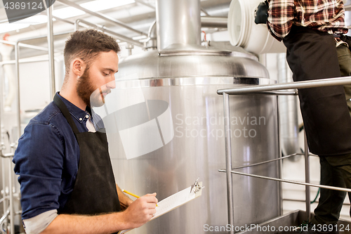 Image of men working at craft brewery or beer plant