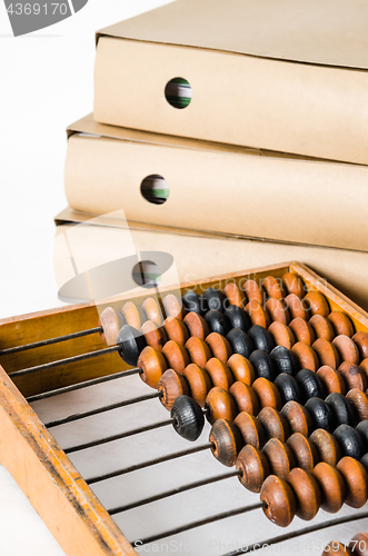Image of Old abacus and folders with documents, close-up 