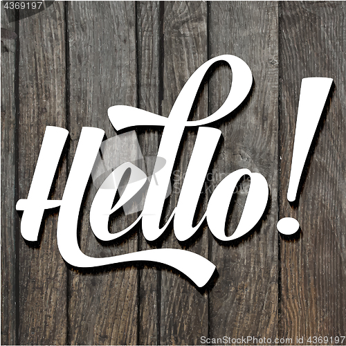 Image of paper cut word HELLO on wooden background