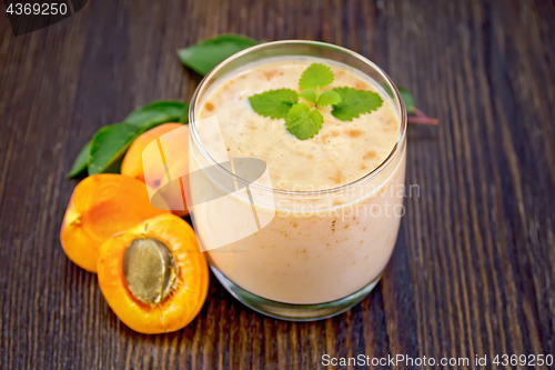 Image of Milkshake apricot in glassful on board