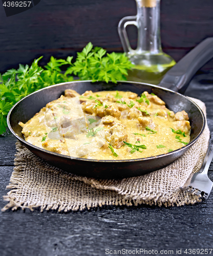 Image of Meat stewed with cream on black board