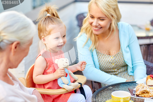 Image of mother, daughter and grandmother at cafe