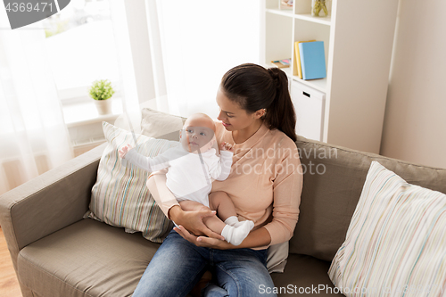 Image of happy mother with little baby boy at home