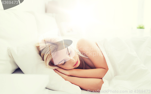 Image of young woman sleeping in bed at home bedroom