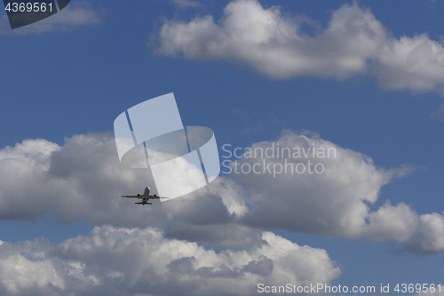 Image of Airplane flies against a background of white cloud