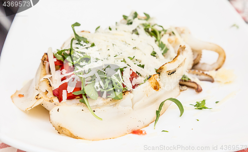 Image of Cuttlefish with tomato, salad and Parmigiano cheese