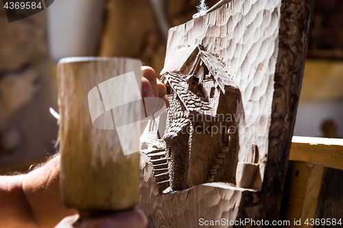 Image of Sculptor hands working wood